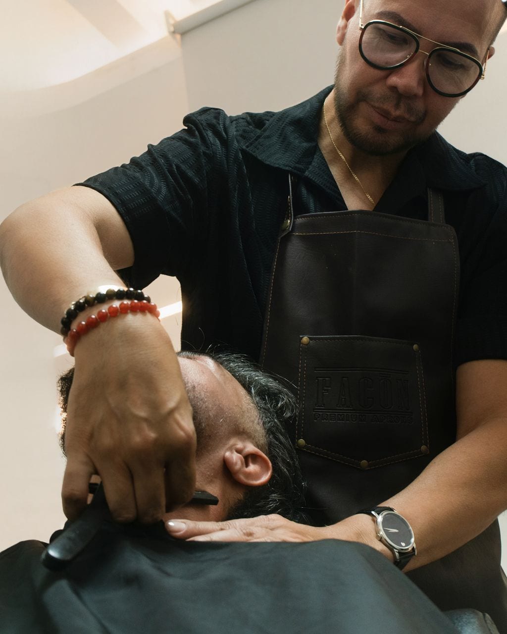 Moses attending to a reclined client during a grooming service